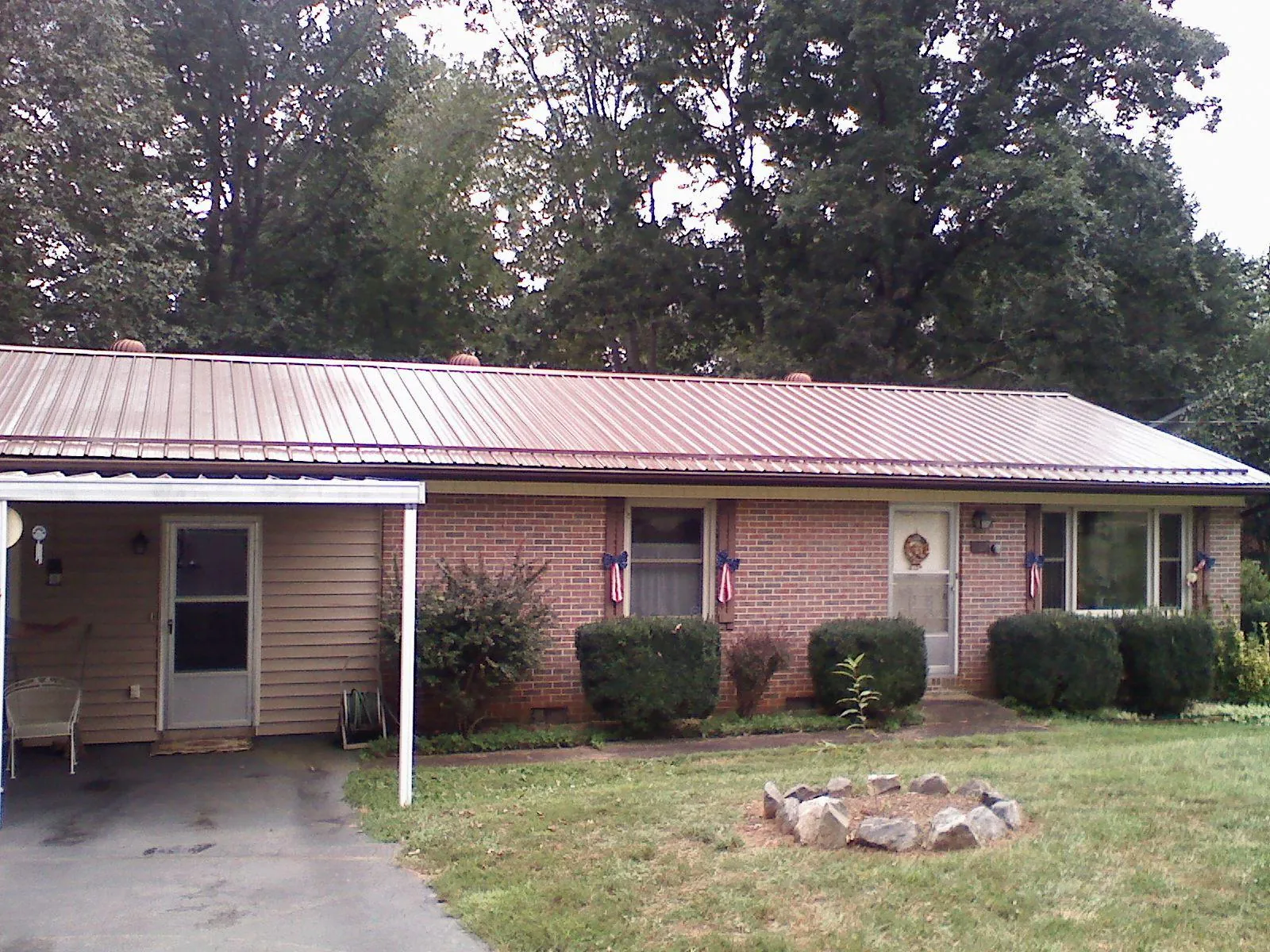 Bronze metal roof and carport on a brick ranch home — Roof Repair work by our crew in College Place